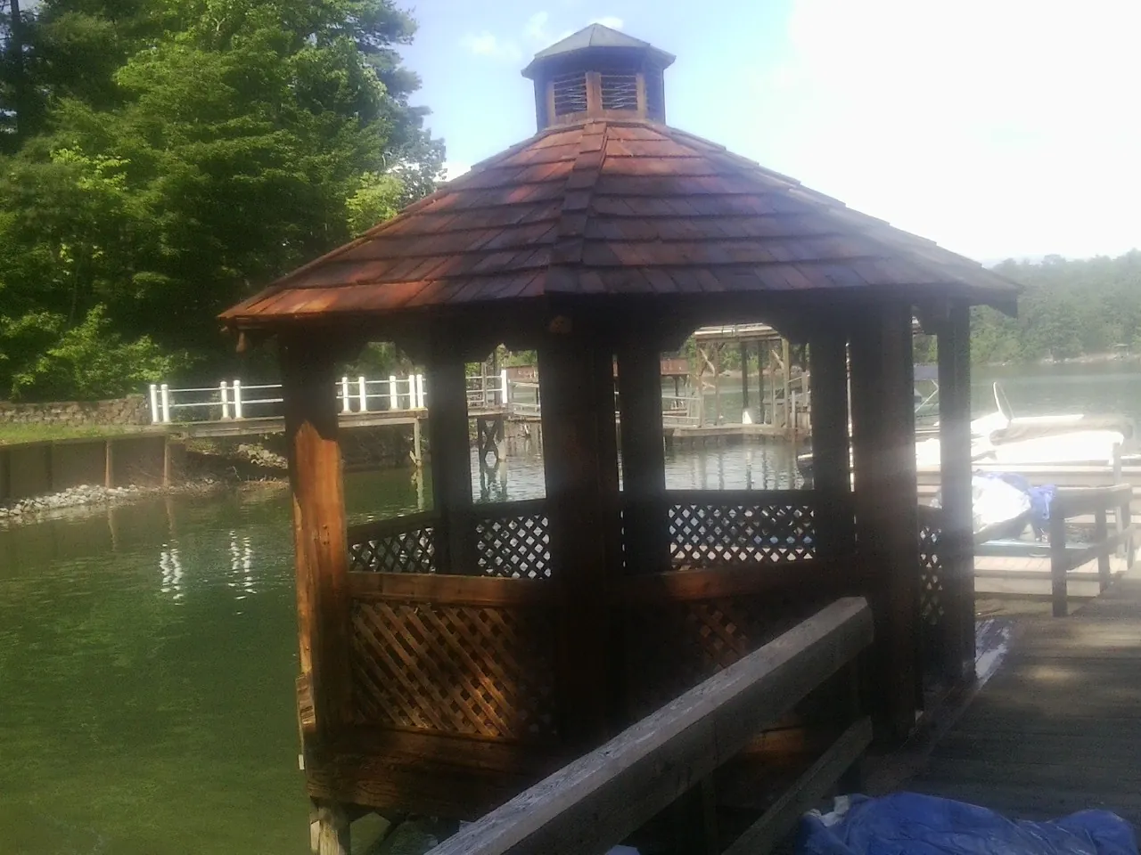 Cedar shake gazebo roof rebuilt on a lake dock in Round Mountain